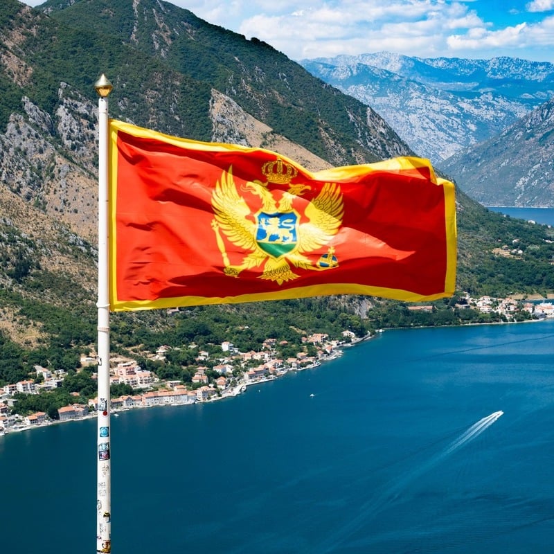 Montenegrin Flag Flying Atop A Fortress Overlooking The Bay Of Kotor, Kotor City, Montenegro, Western Balkans, South Eastern Europe