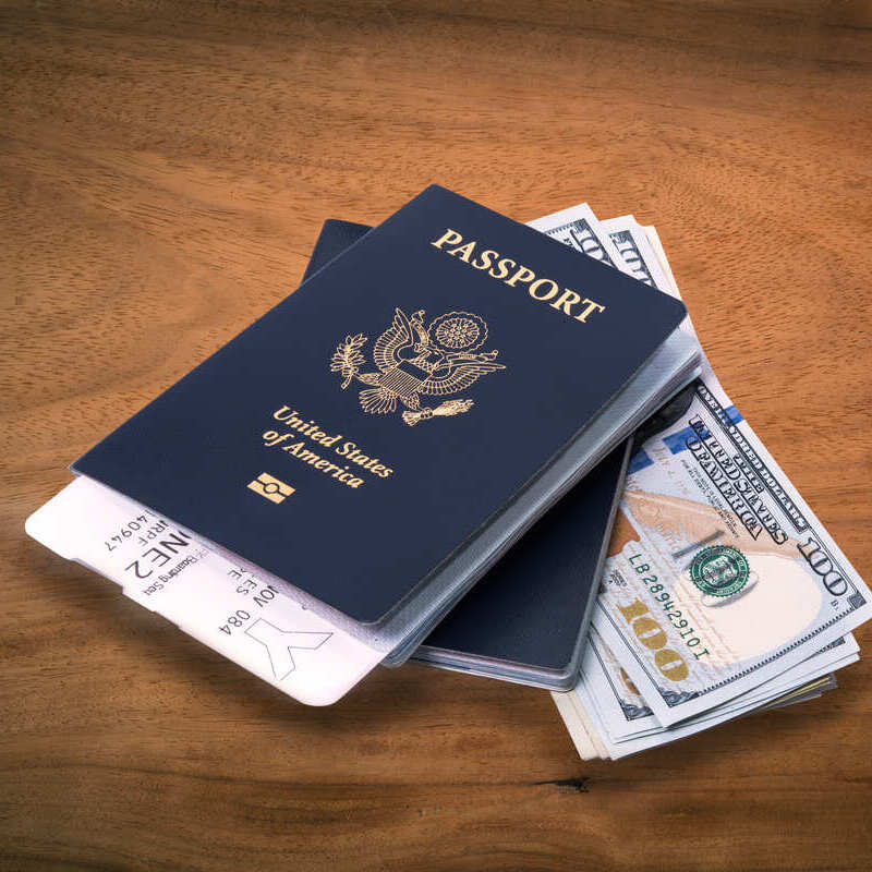 US Passports Pictured With Boarding Passes And US Dollars