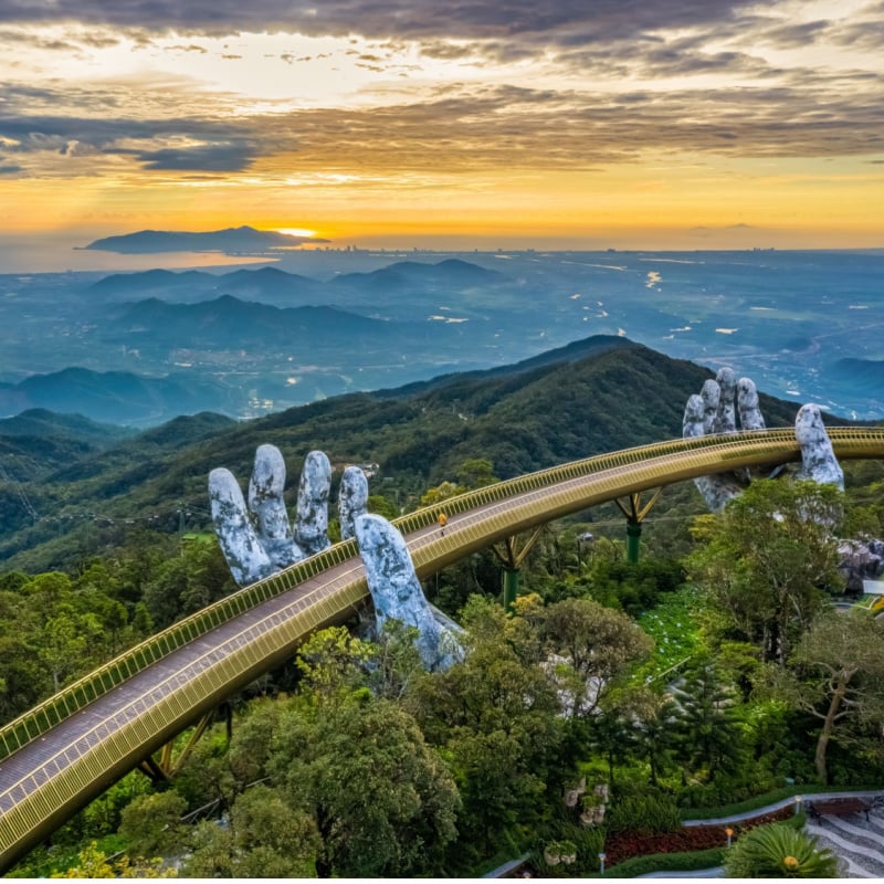 Golden bridge lifted by hands in Vietnam