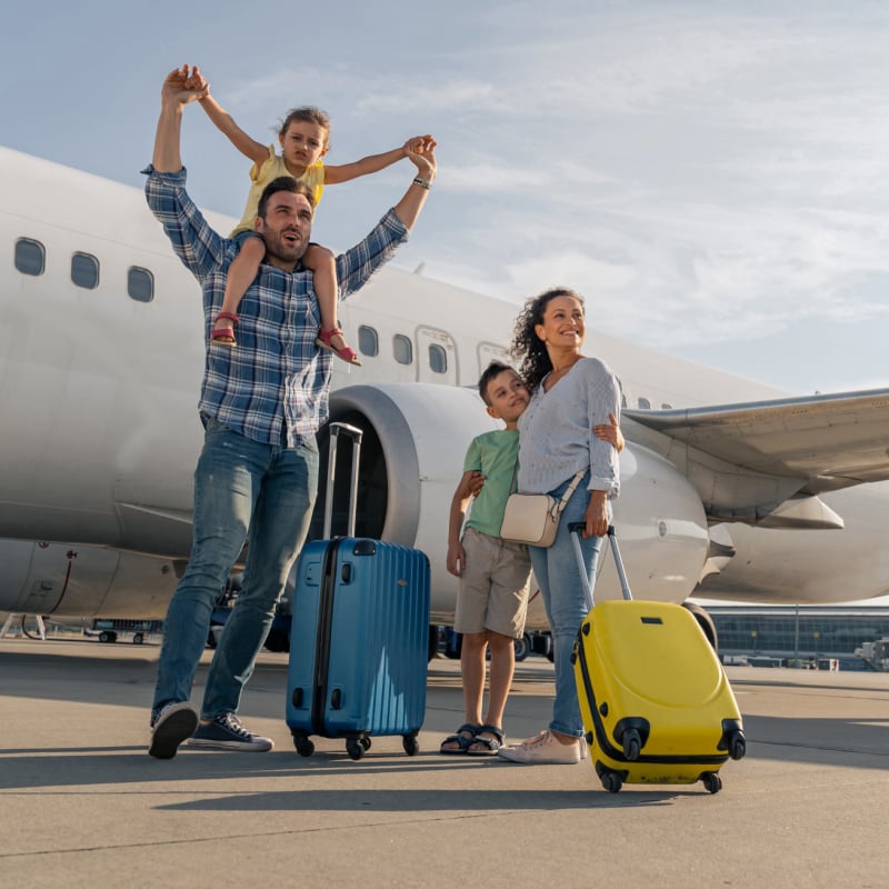 family standing in front of a plane