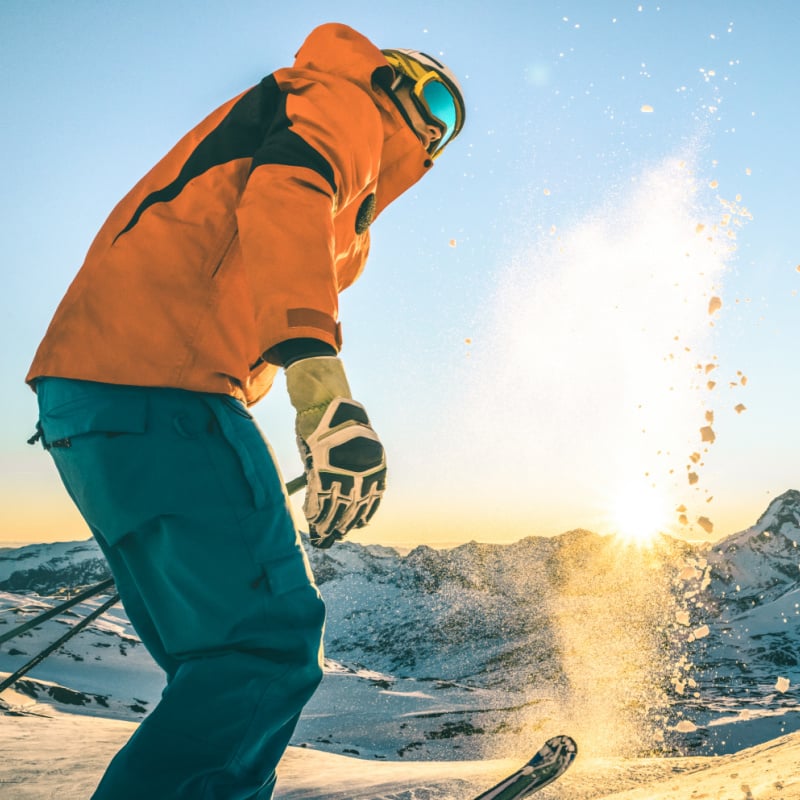 man skiing on sunny day in the mountains