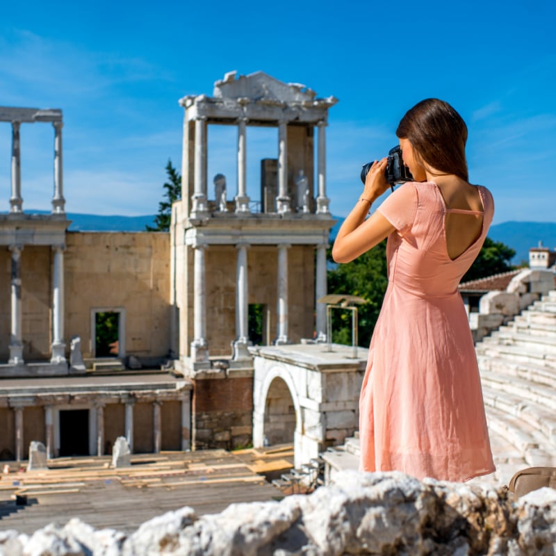 woman tourist photographing ancient theater in Plovdiv, Bulgaria