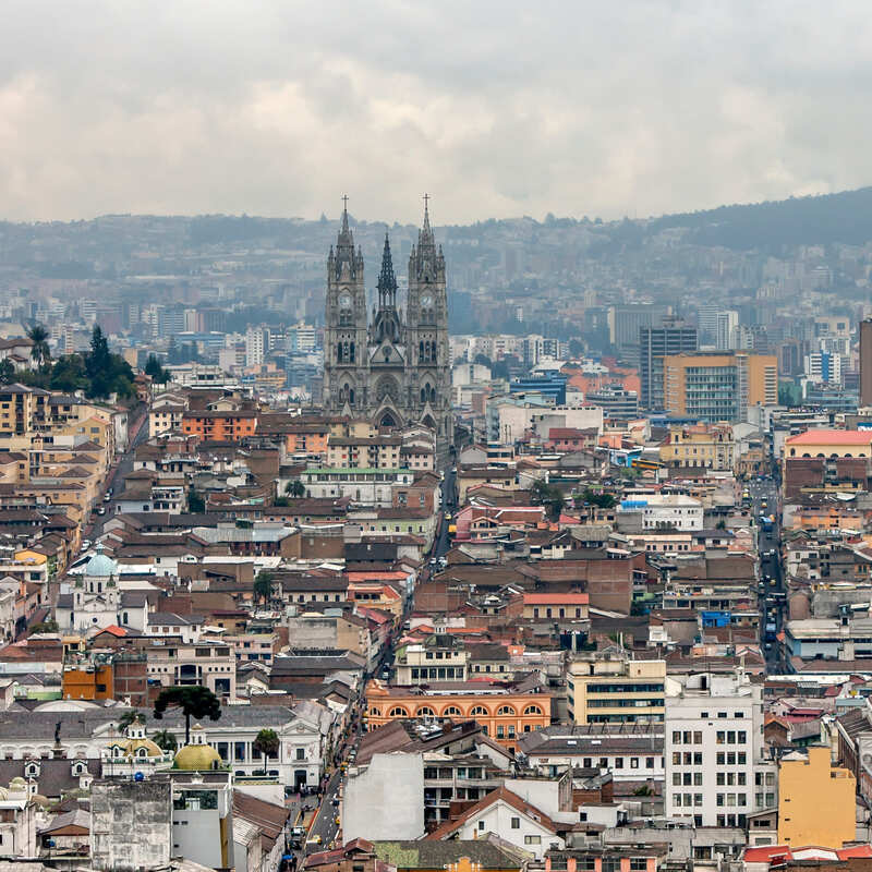 Aerial Shot Of Downtown Quito, With The Colonial Cathedral Towering Above A Sea Of Modern Buildings, Ecuador, South America