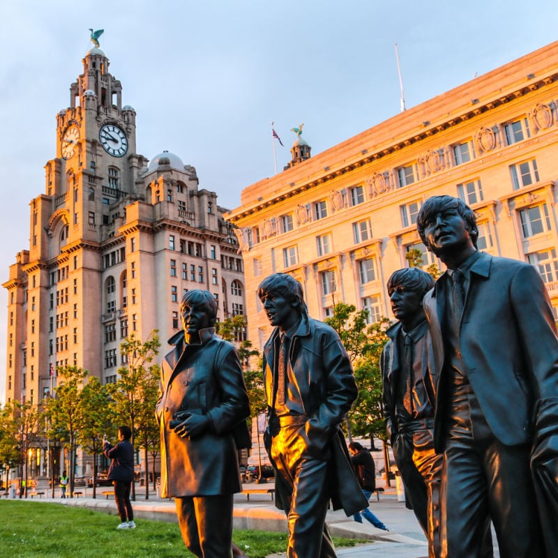 beatles statues outside of the liver building in liverpool england