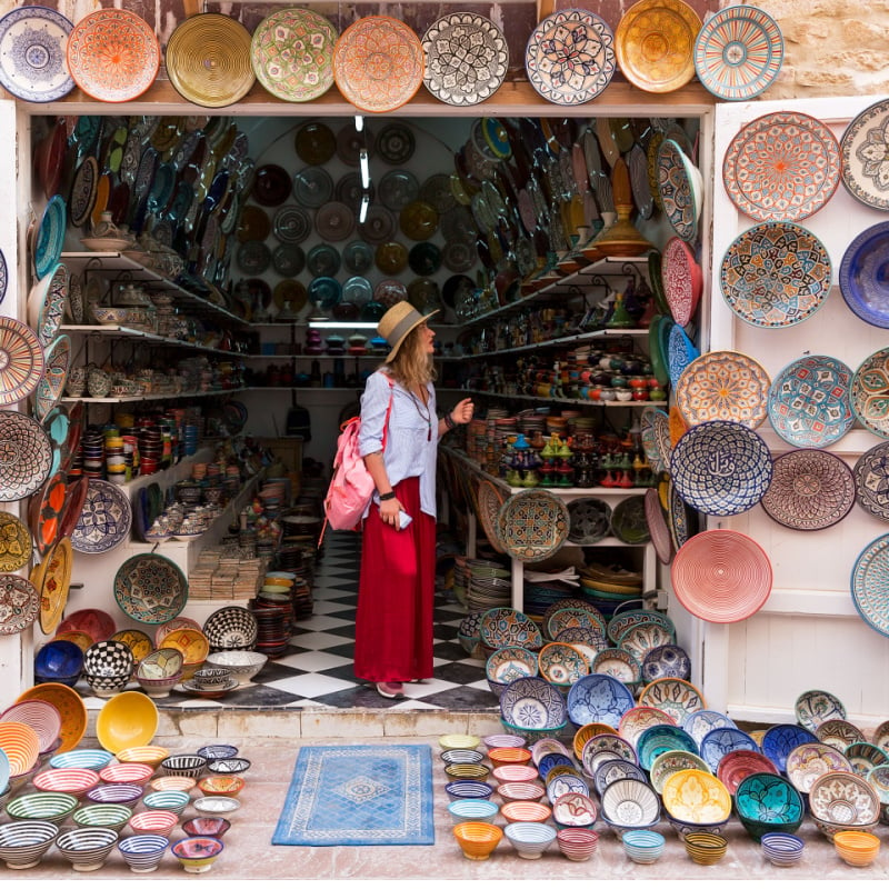 standing in a small shop and looking at Moroccan colorful plates