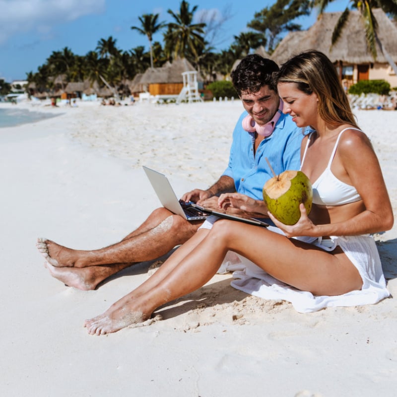 Man and woman on beach in mexico that are digital nomads, Latin America