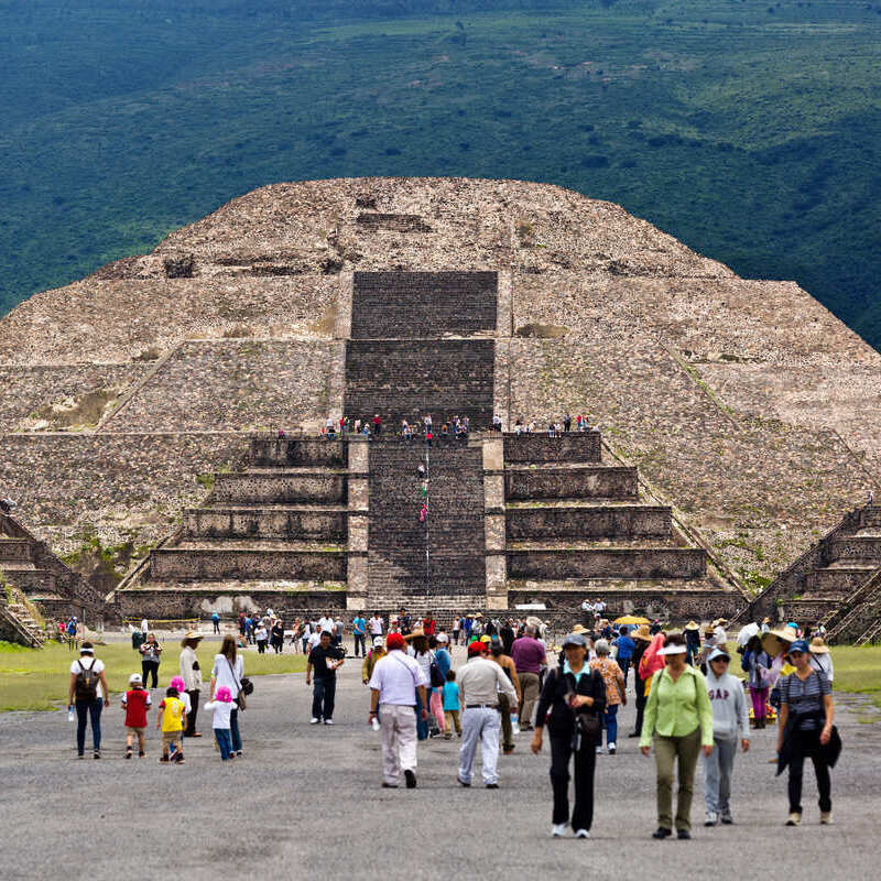 A Crowd Of Tourists Walking Up To The Pyramid Of The Sun In Teotihuacan, Close To Mexico City, Mexico, Latin America