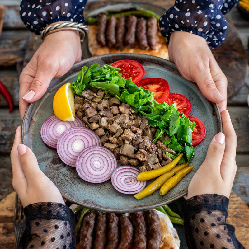 Women Passing Over Albanian Food During A Banquet, Albania, South Eastern Europe 