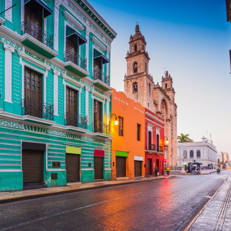 Colorful historic buildings on quiet street in Merida