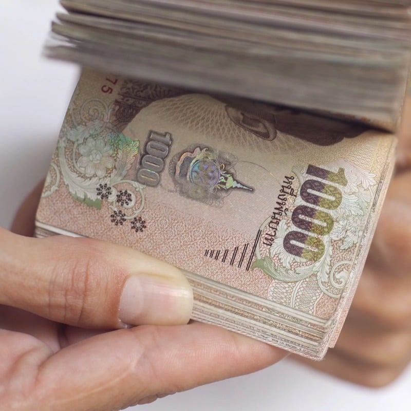 Someone Counting Notes Of Thai Baht, The National Currency Of Thailand, Southeast Asia