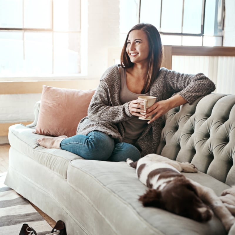 Woman relaxing with her dog at home