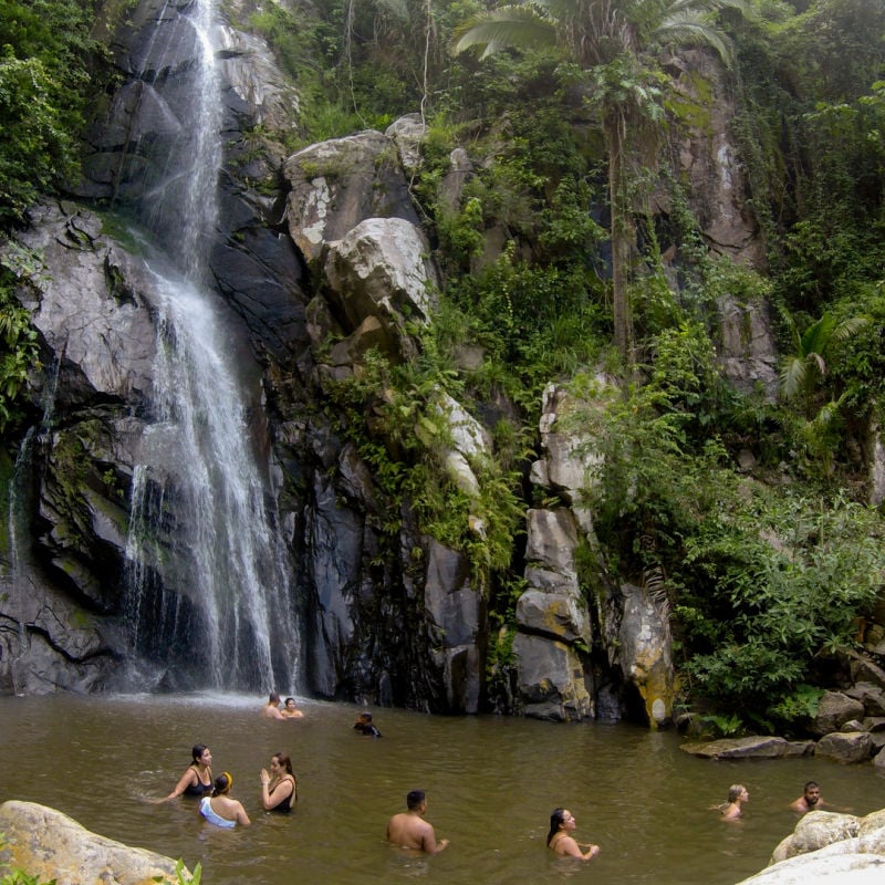 Tourists swimming at waterfall in Yelapa