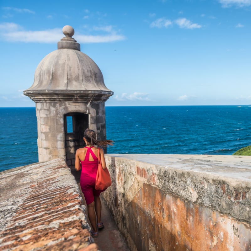 Woman Admiring The Coastal Views In A Fortress In San Juan, Puerto Rico, United States