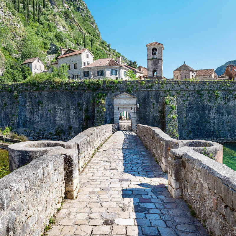 City Walls And Medieval Bridge In Kotor, Montenegro, Bay Of Kotor, Dalmatian Coast Of South Eastern Europe