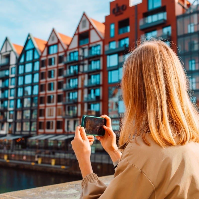 Young Woman Taking Pictures Of The Motlawa Waterfront In Gdansk, Pomerania, Poland, Central Eastern Europe.jpg