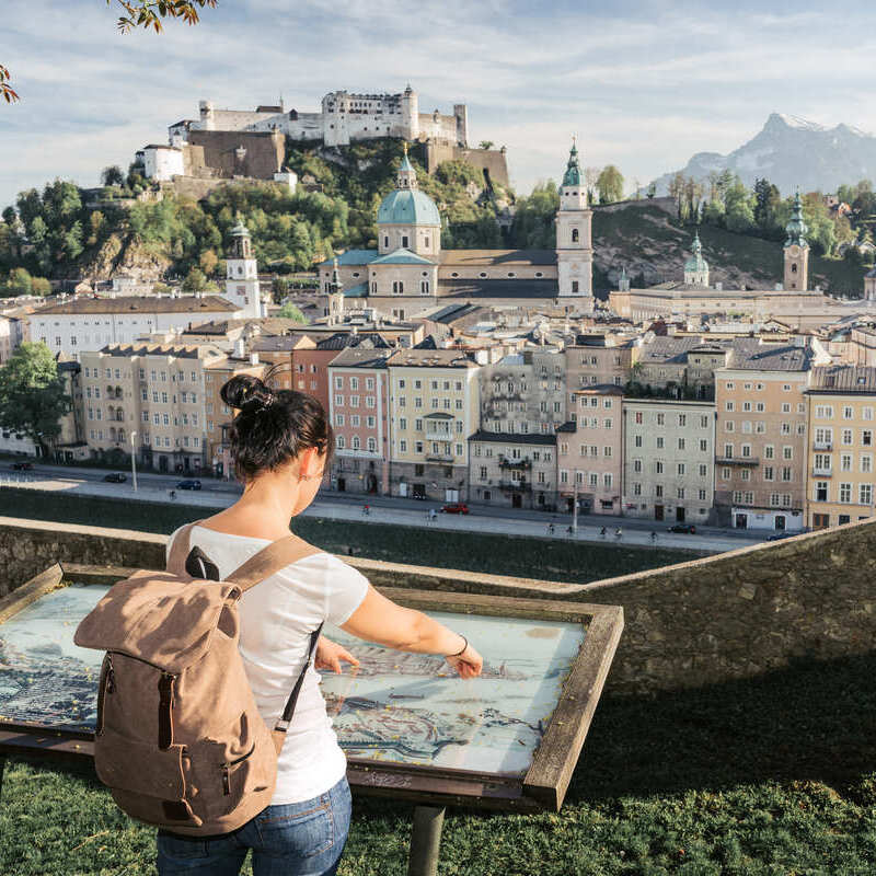 A Young Woman Admiring Views Of Salzburg Old Town In Austria, Central Europe