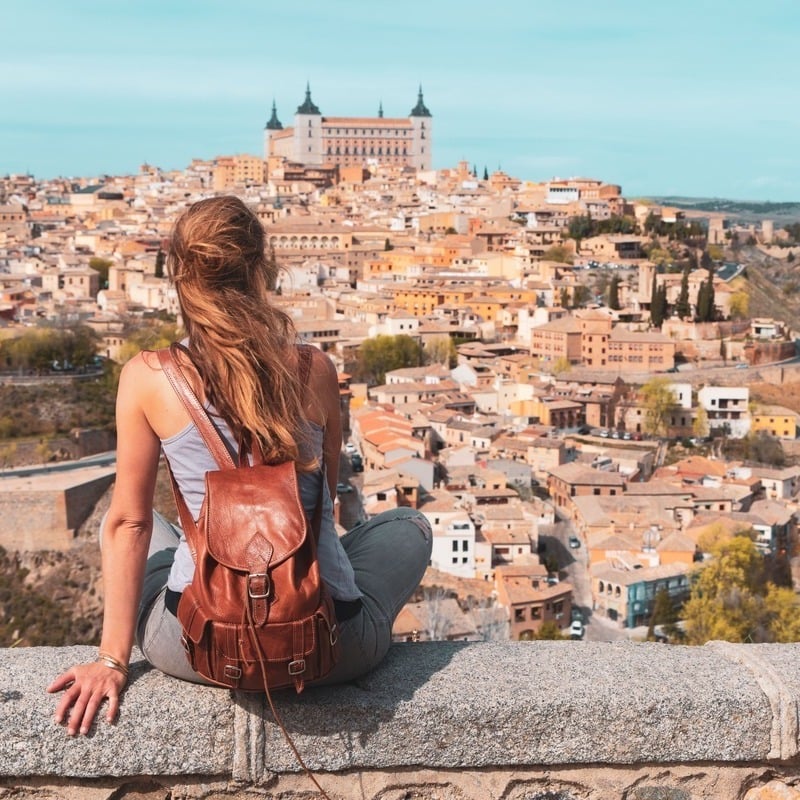 A Young Woman Sat On A Lookout Admiring Toledo, A Small City In Central Spain, Iberian Europe, Southern Europe