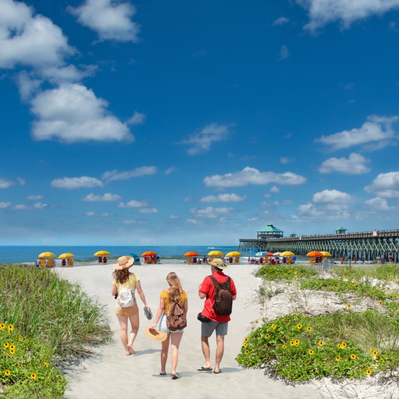 Family entering Folly Beach, SC on nice day