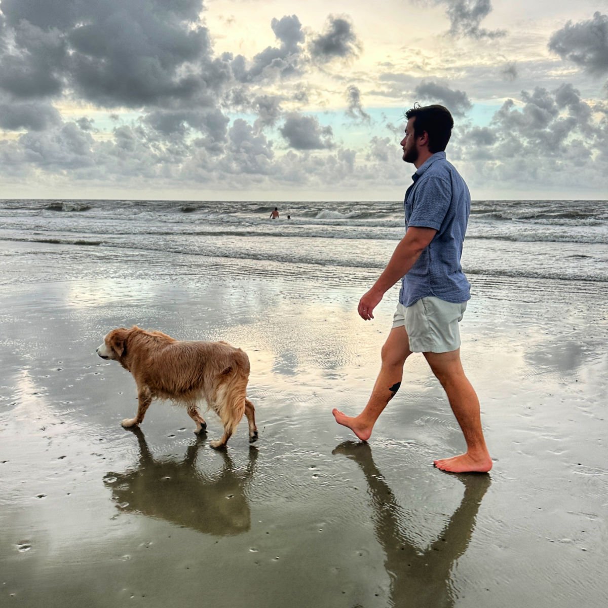 Managing Editor Tyler Fox walking on Fripp Island Beach with dog in South Carolina