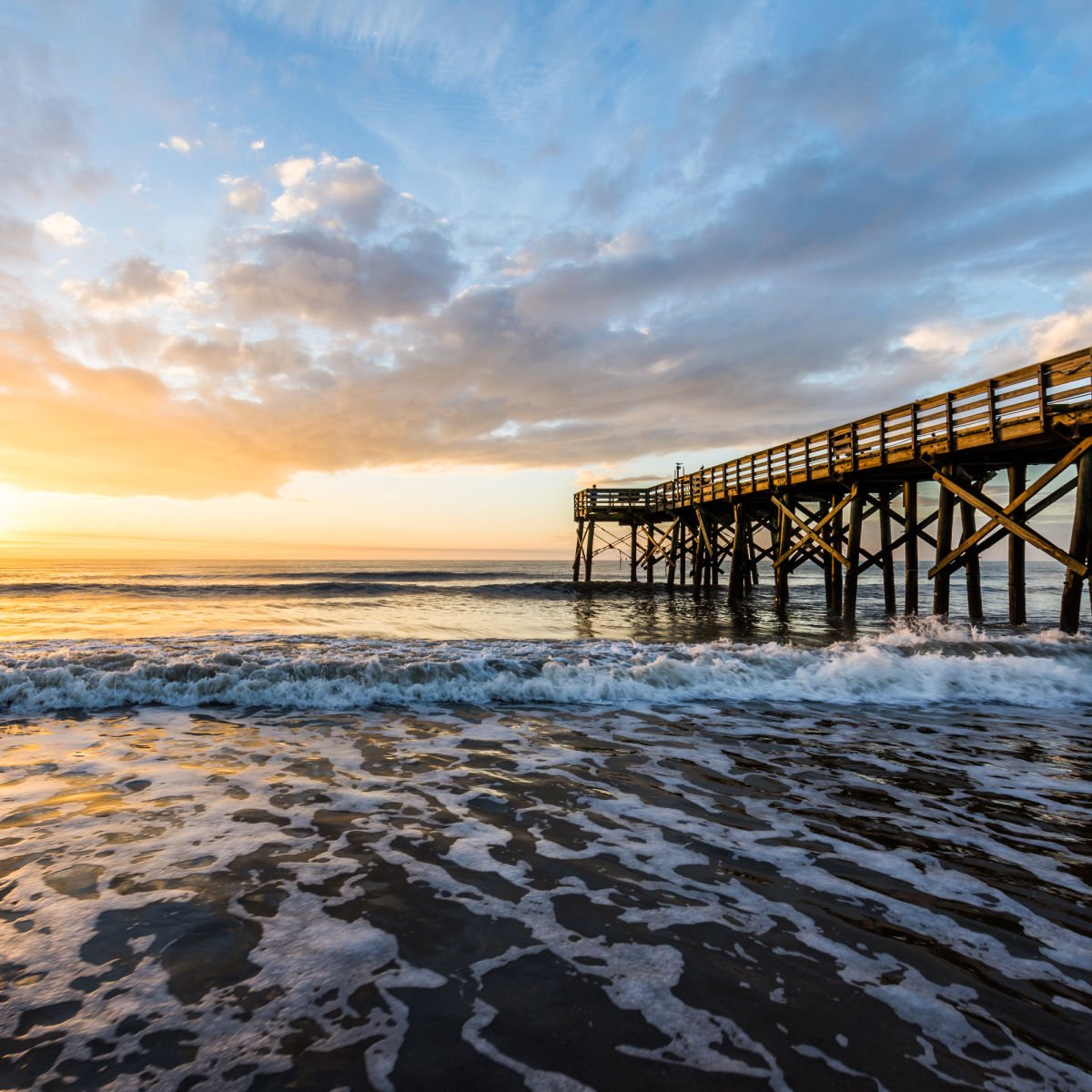 Waves crashing under pier in Isle of Palms, SC