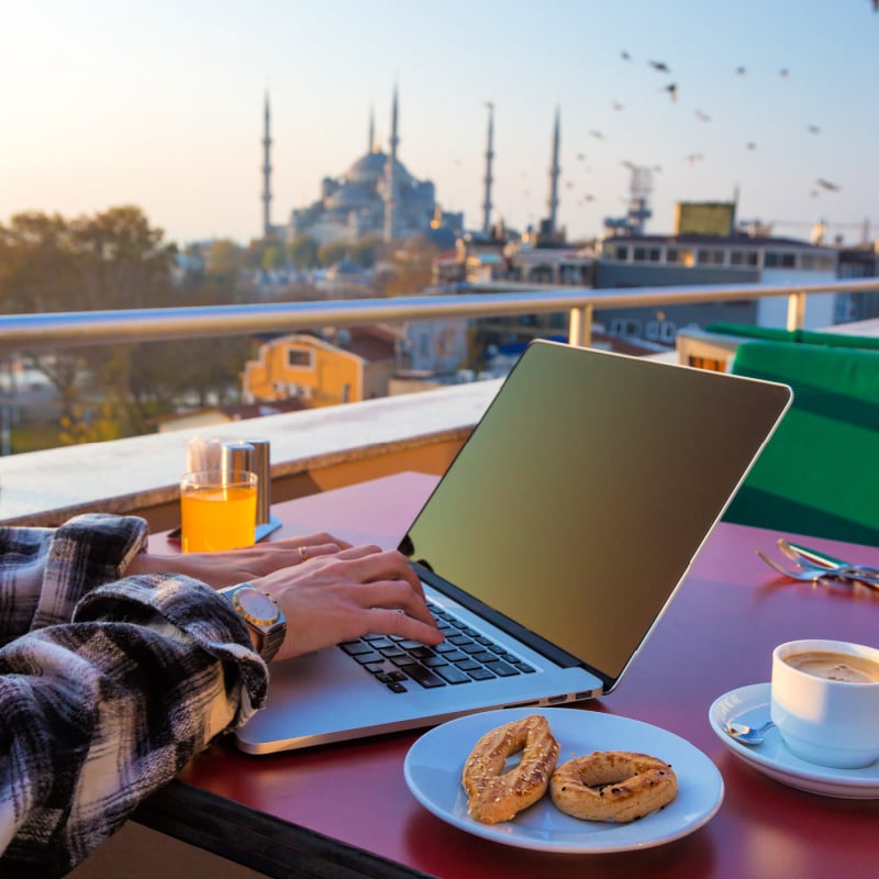 Woman working on her laptop in Istanbul, a middle eastern city that is the best for digital nomads