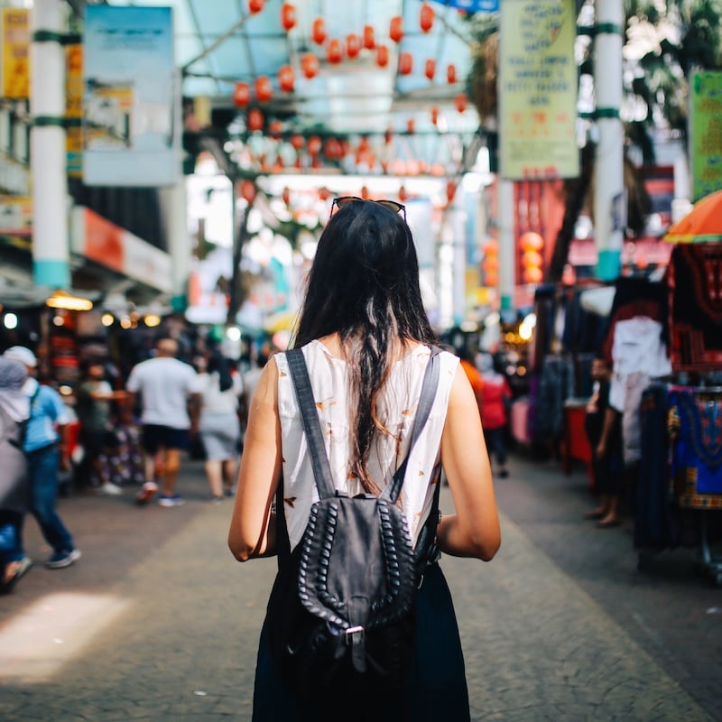 Young Female Tourist Seen From Behind As She Stares At The Chinatown Of Kuala Lampur In Malaysia, Southeast Asia