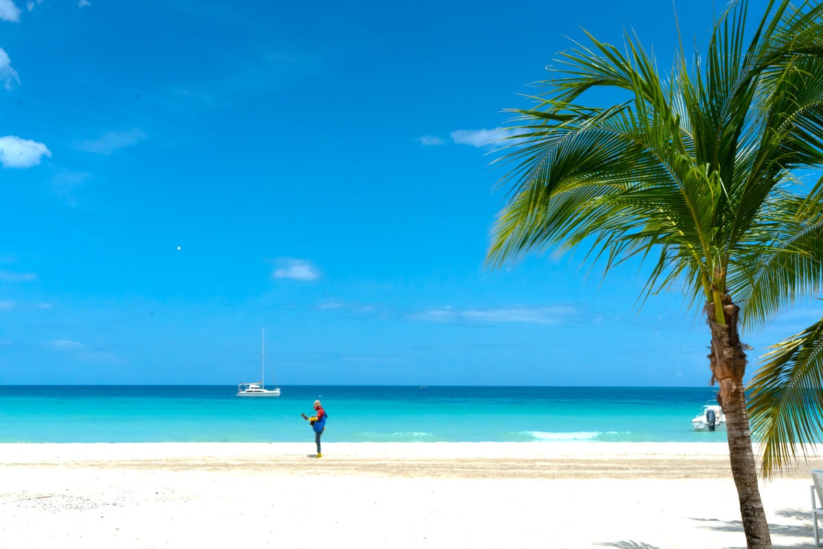 Man in Jamaica playing the guitar on 7-mile beach