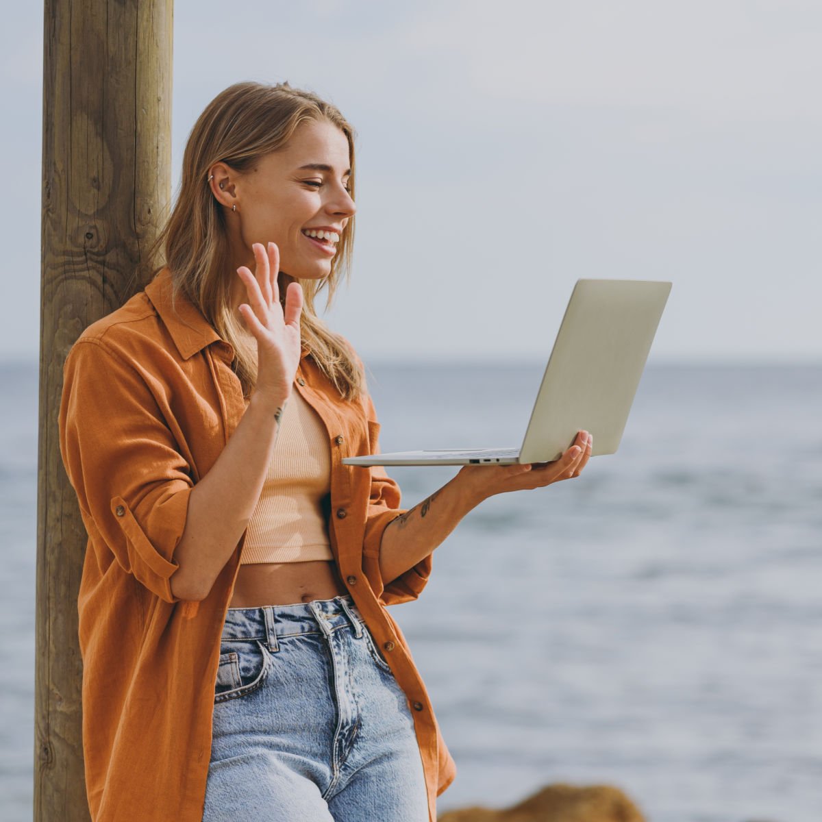 Remote worker on virtual meeting at beach