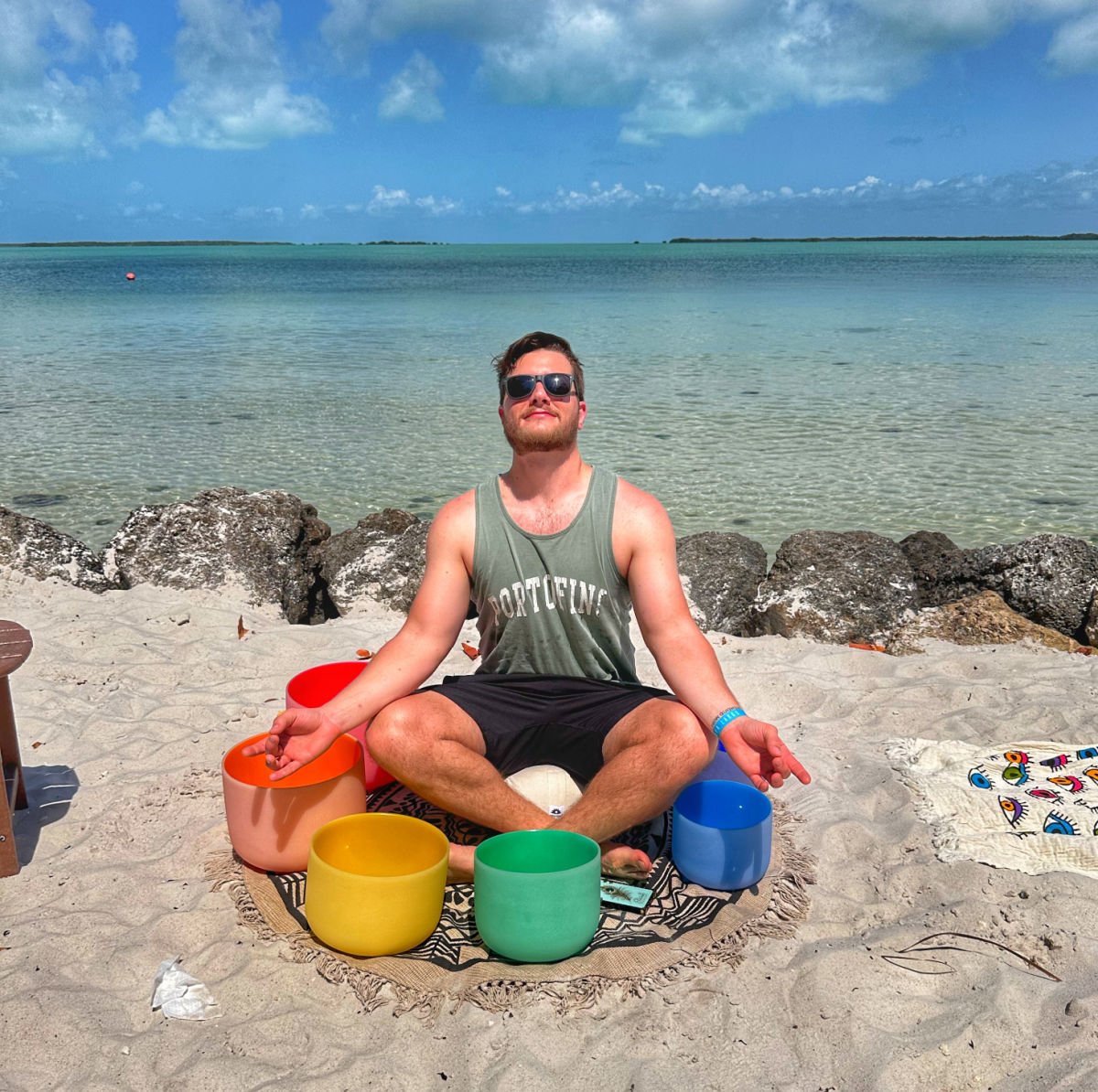 Tyler Fox posing with sound bowls after sound bathing at Playa Largo