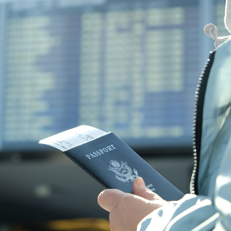 Traveler Holding United States Passport At Airport, Unspecified Location