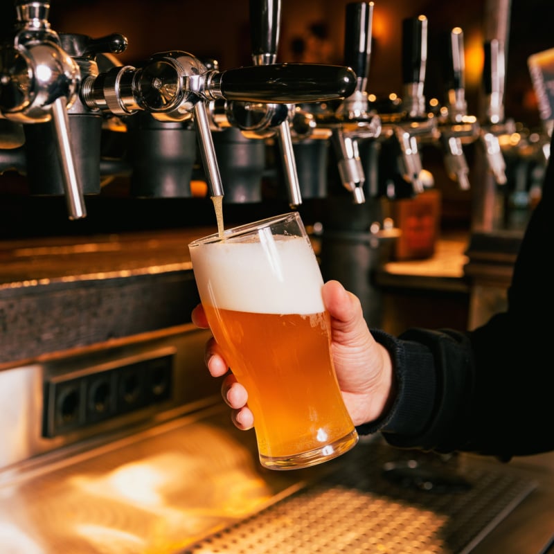 Beer glass being filled at brewery