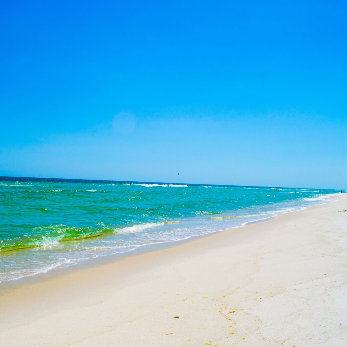 Emerald green waters and white sand of Fort Pickens