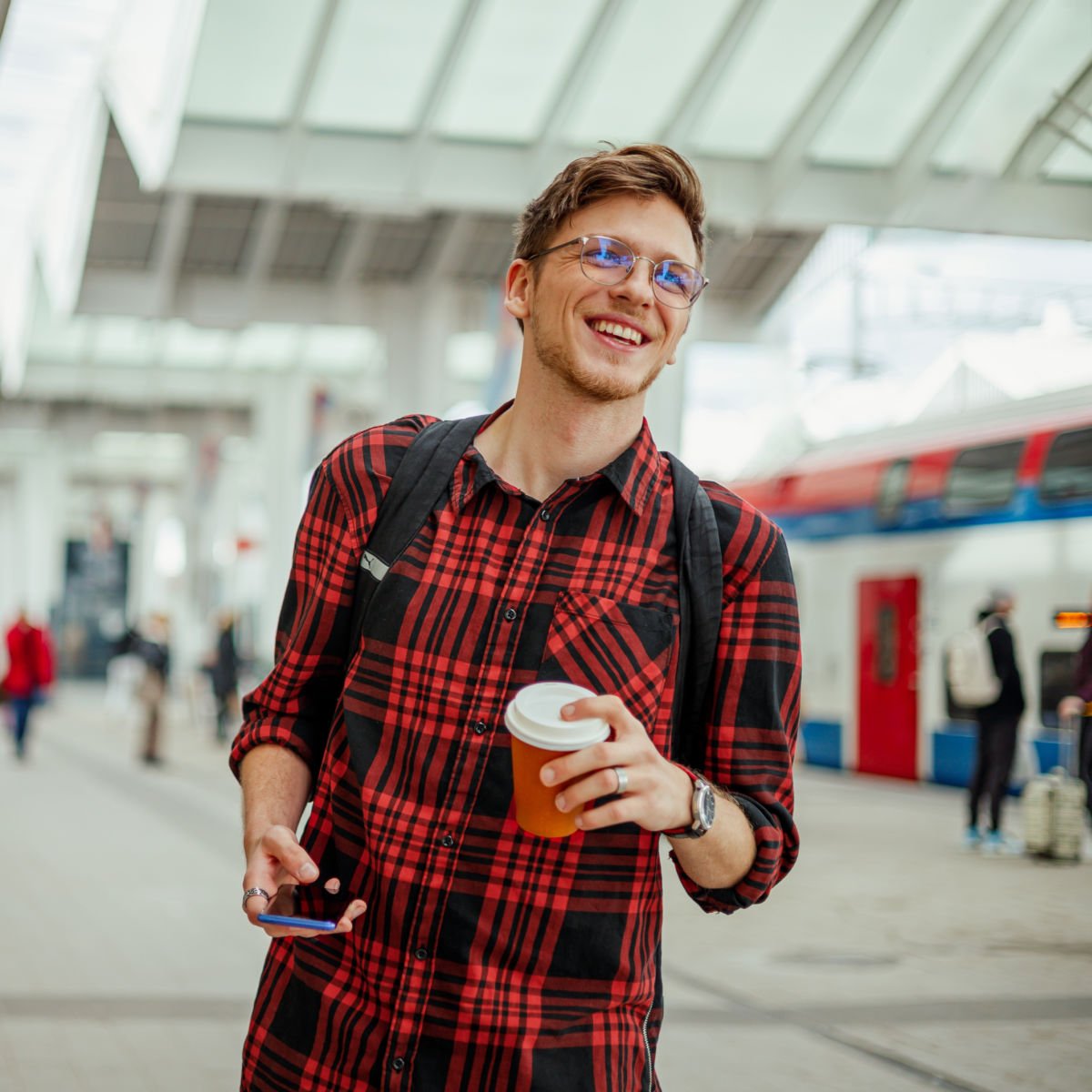 Fall train traveler in flannel with coffee