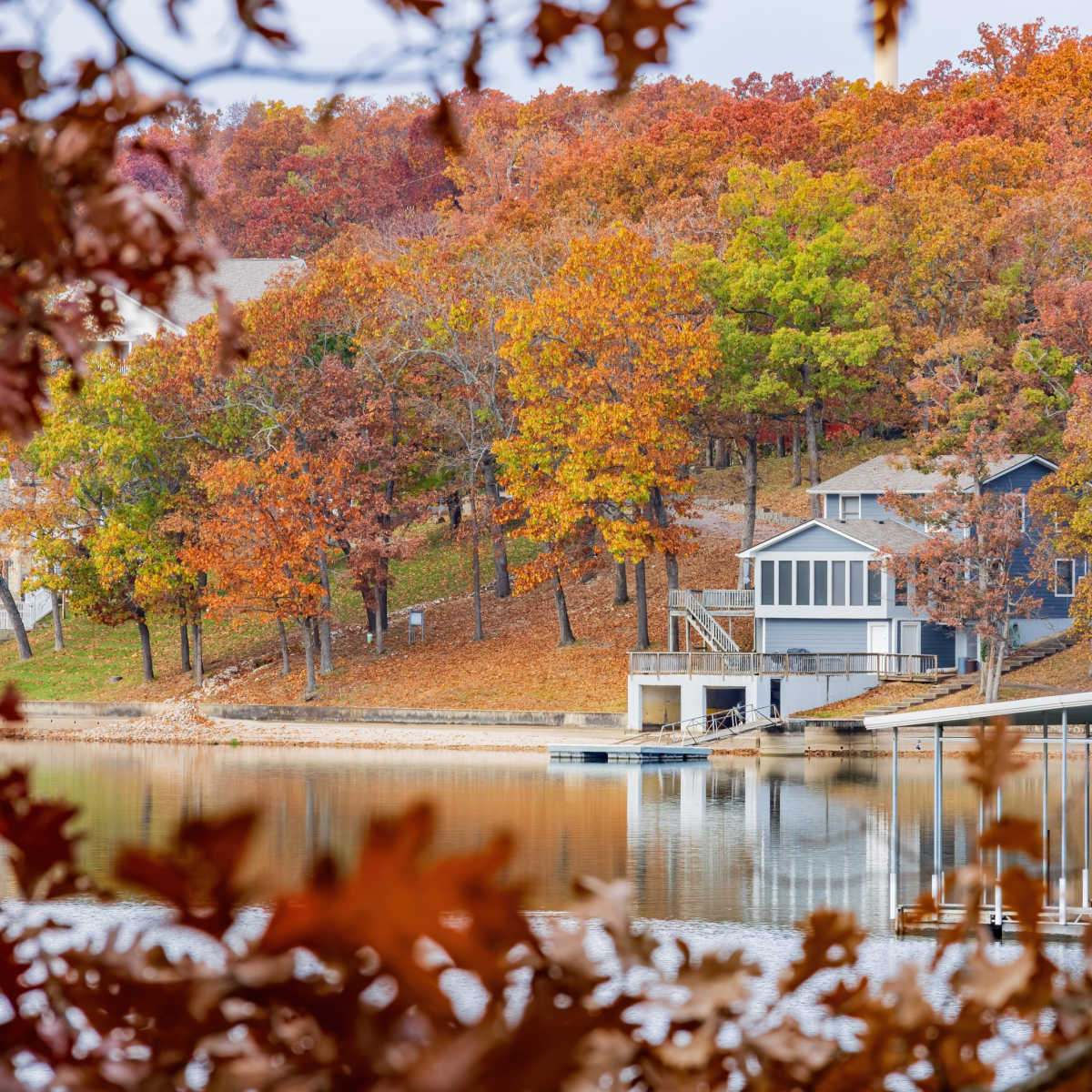 house on a lake in the fall