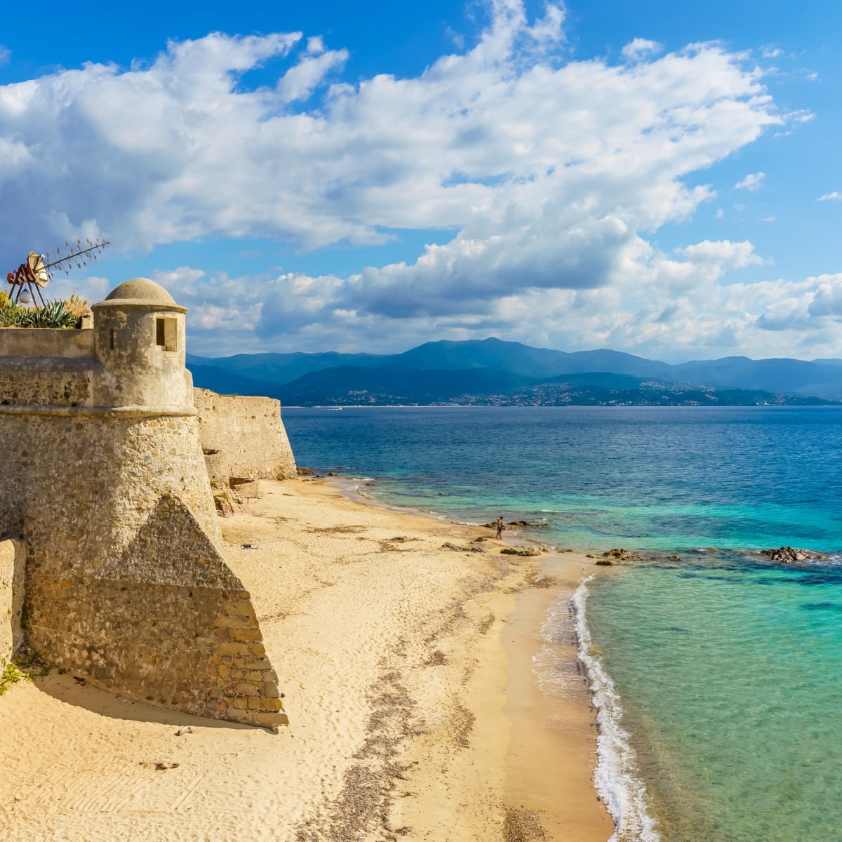 Old citadel on pristine Corsica beach