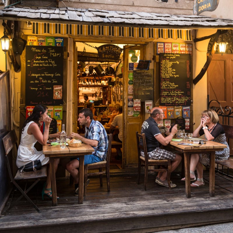 Patrons enjoying cozy eatery in Corsica