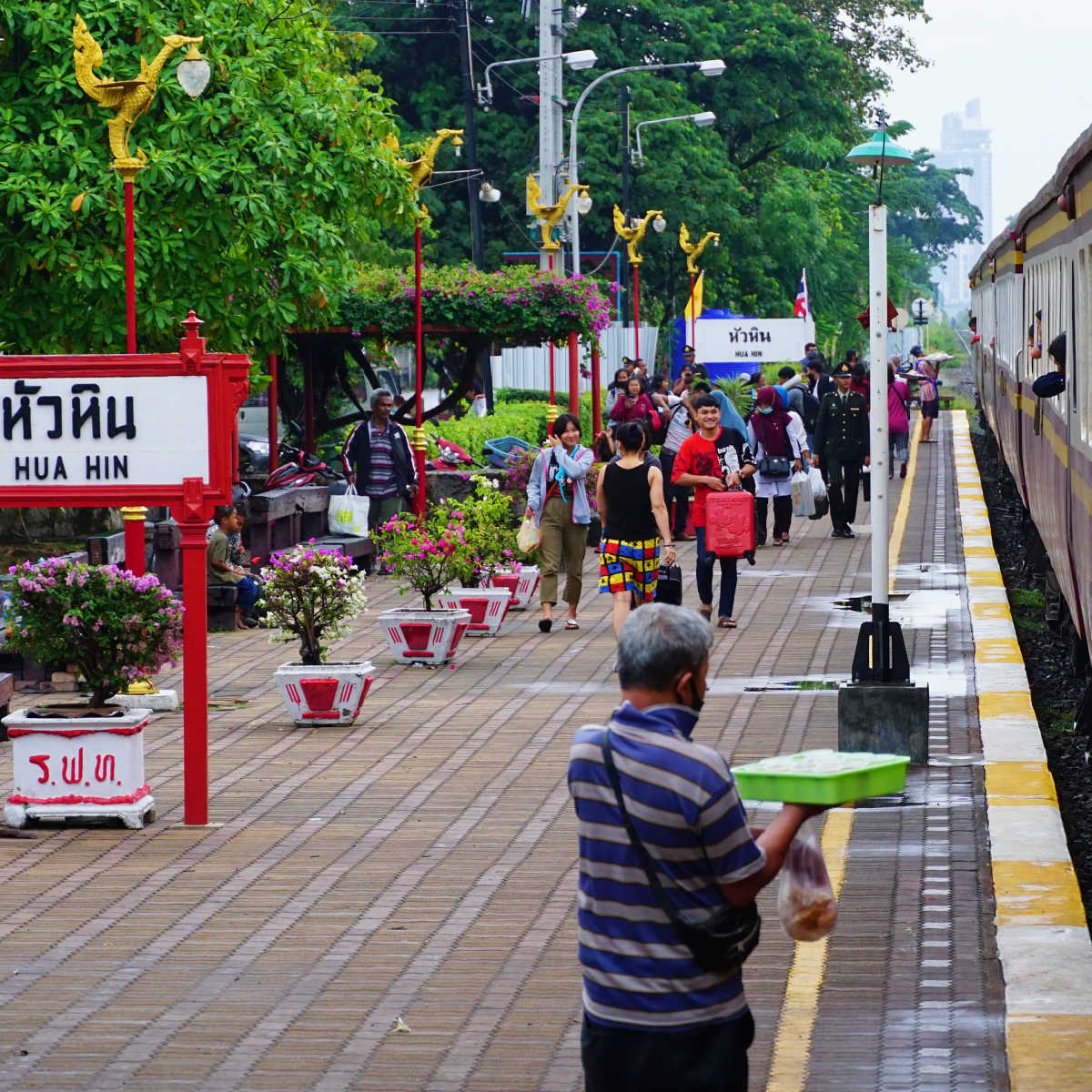 People walking through Hua Hin train station