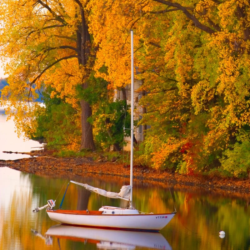 Small sailboat on Lake Champlain in fall