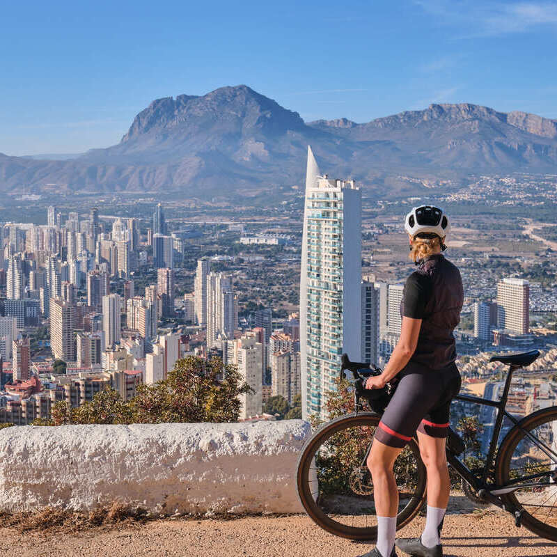 Cyclist Woman Admiring Benidorm, Spain