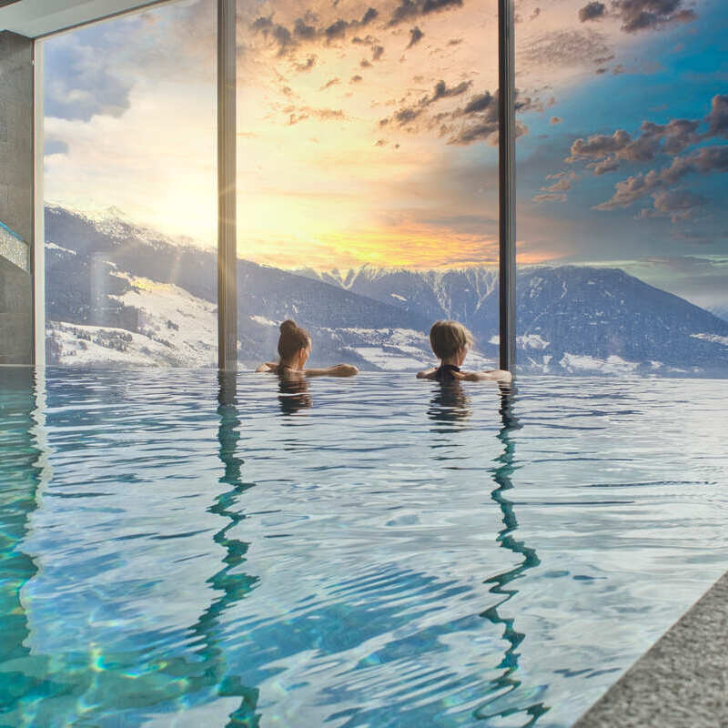 Tourists Enjoying A View Of The Austrian Alps In A Spa Resort