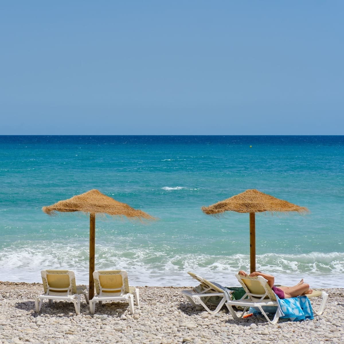 Woman Lounging On A Beach In Benidorm, Spain