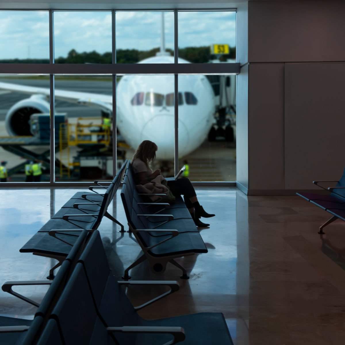 Woman waiting for her flight inside the Cancun Airport